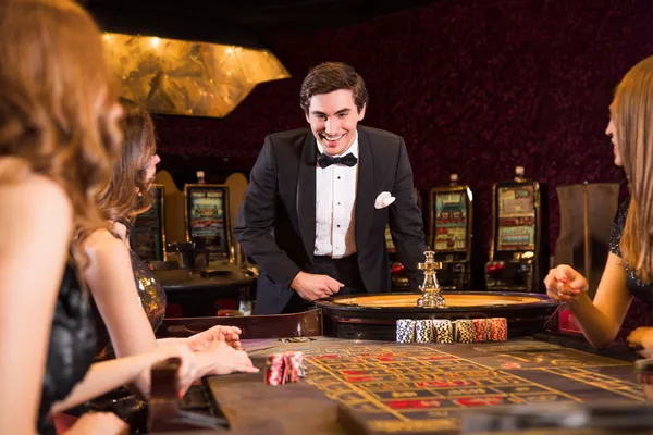A stylish woman beside vibrant slot machines displaying glowing sevens, showcasing the variety of top slots at JILI7979.