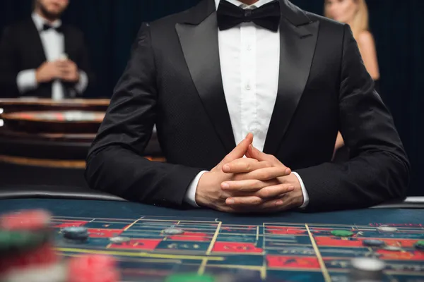 A woman in a luxurious green gown next to an ornate roulette wheel, capturing the upscale casino mood of JILI7979.