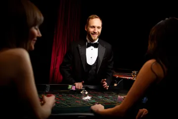 A player using their smartphone during a festive local event, representing JILI7979’s fully mobile-friendly casino.